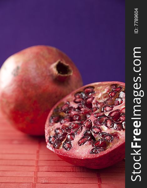 Fresh pomegranate halves, tropical fruit