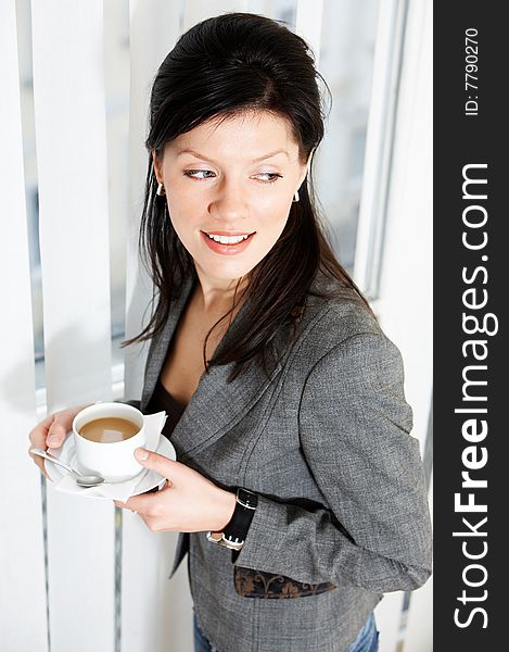 Young happy caucasian businesswoman with cup of coffee. Young happy caucasian businesswoman with cup of coffee