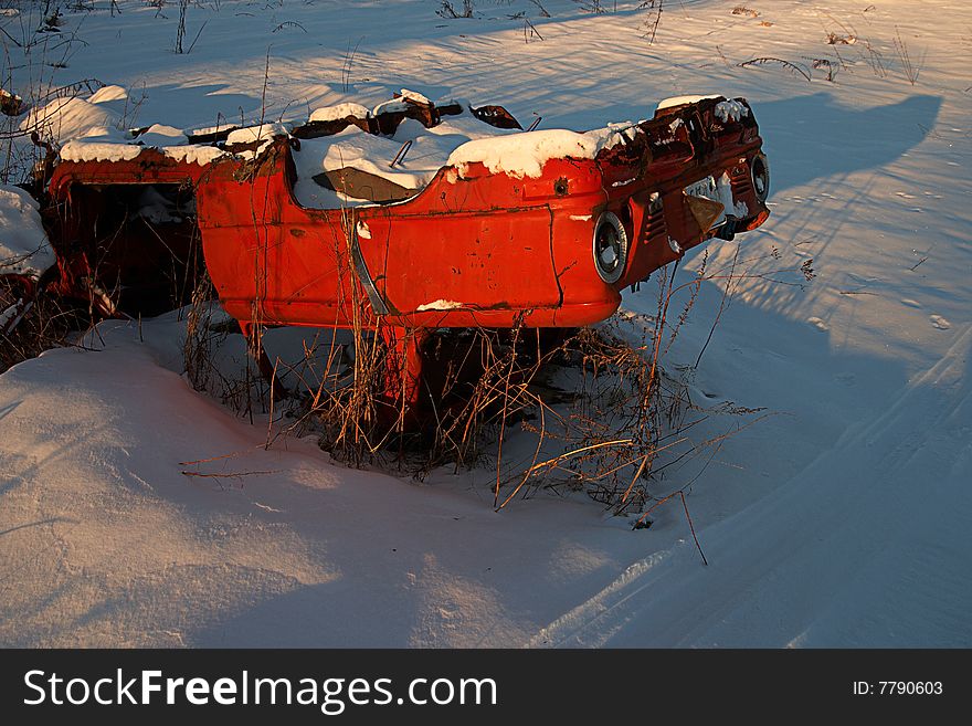 Old broken, abandoned, rusty carl ying on snow. Old broken, abandoned, rusty carl ying on snow