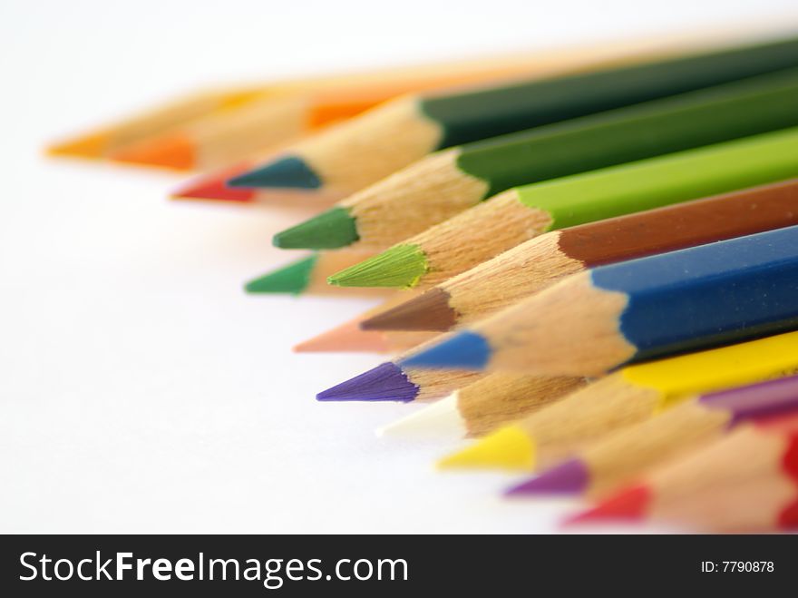 Multi colored pencils against white background. Multi colored pencils against white background