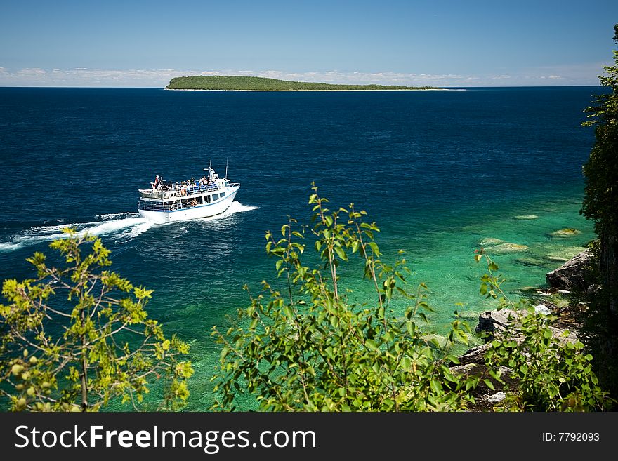 Tour boat cruising around an Island. Tour boat cruising around an Island