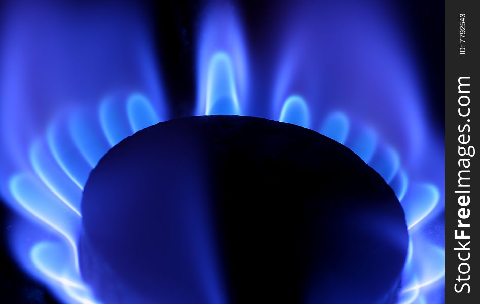 Blue flame of gas on black backround