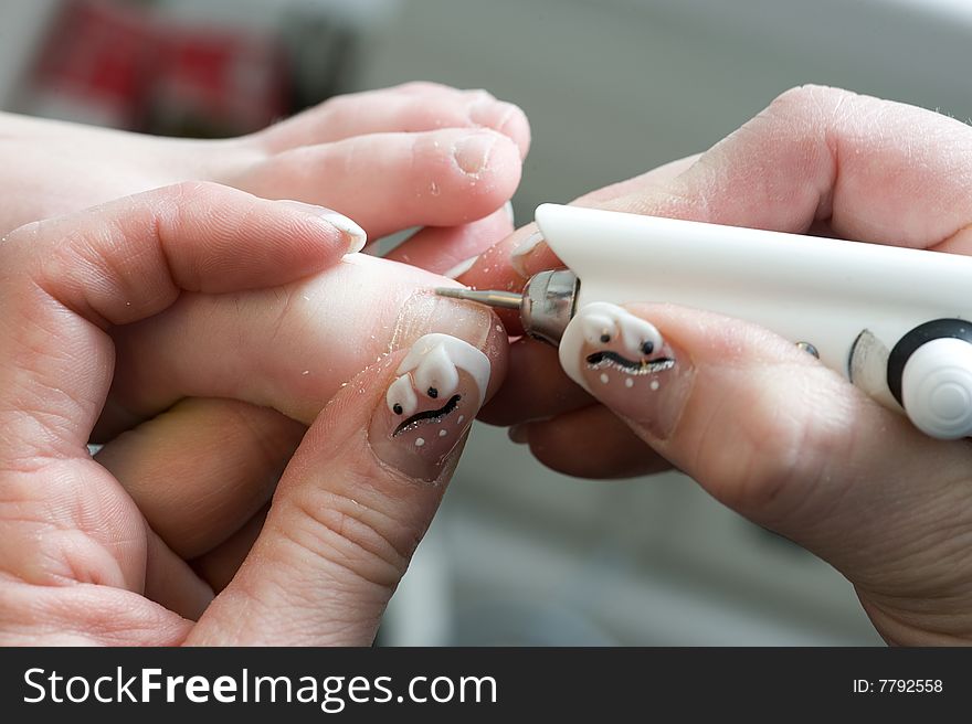 Foot therapist working on a girls nails. Foot therapist working on a girls nails