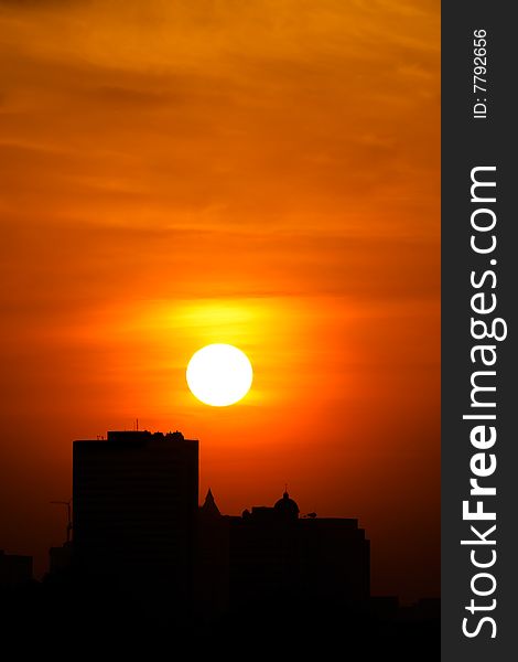 Picture of buildings with sun setting in the background. Picture of buildings with sun setting in the background.