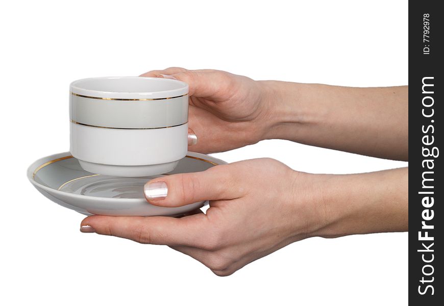 Cup and saucer in female hands on the isolated