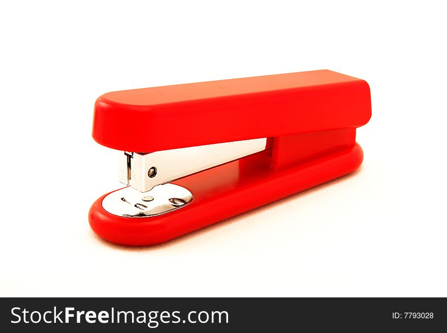 Red stapler on white background