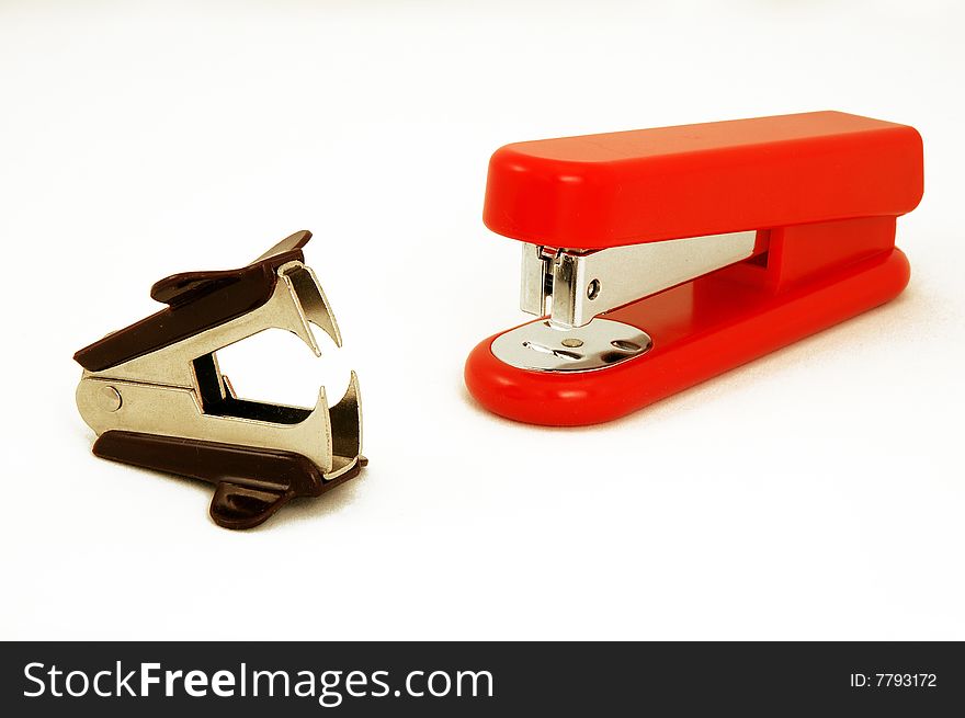 Red stapler and stapler remover on white background. Red stapler and stapler remover on white background