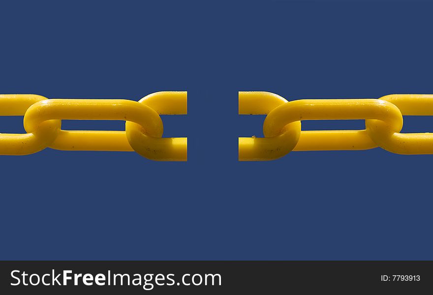 Close up of broken chain link set against blue sky background for copy text