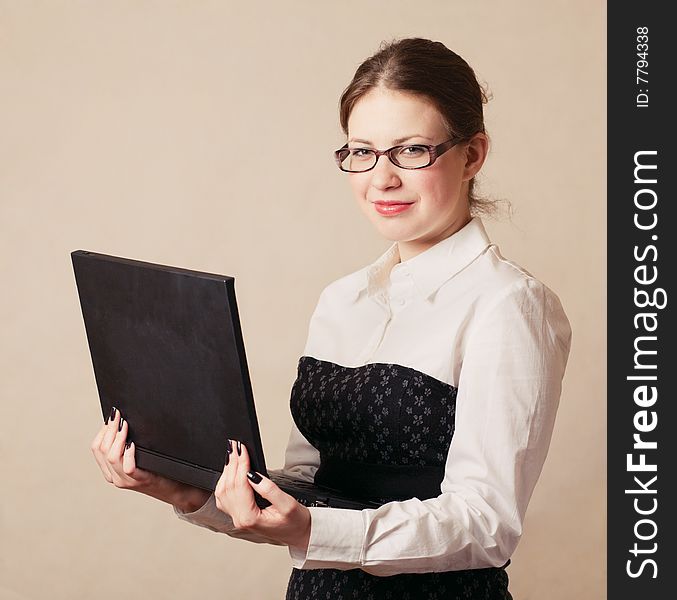 Young business woman holding a laptop. Young business woman holding a laptop