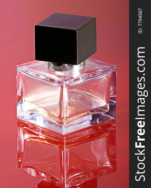 Bottle of a perfume for women on a red background