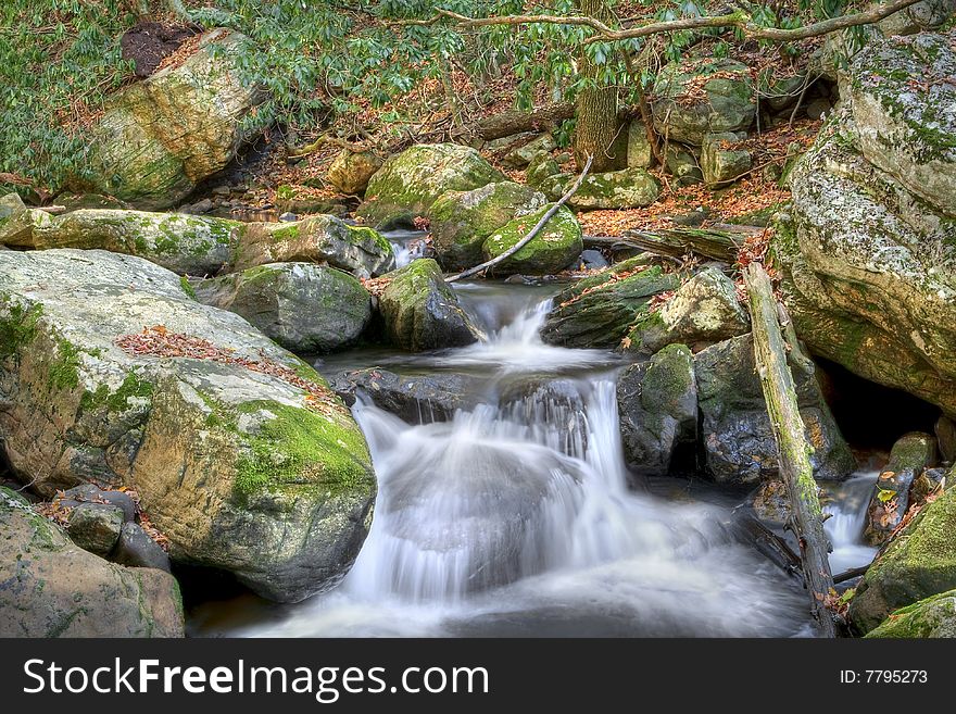 Beautiful waterfall in the middle of the forest during autumn. Beautiful waterfall in the middle of the forest during autumn.