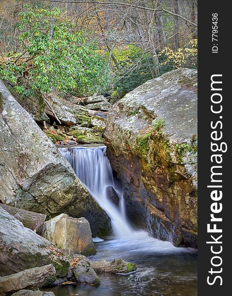 Beautiful waterfall in the middle of the forest during autumn. Beautiful waterfall in the middle of the forest during autumn.