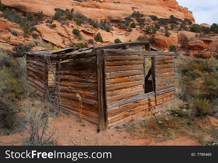 Old farm house in the desert with a red rock background. Old farm house in the desert with a red rock background