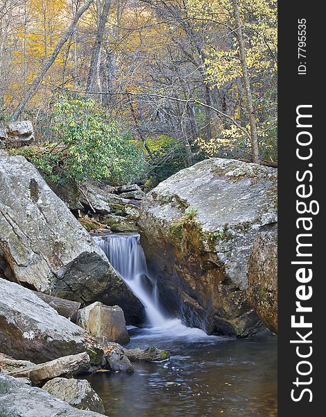 Beautiful waterfall in the middle of the forest during autumn. Beautiful waterfall in the middle of the forest during autumn.