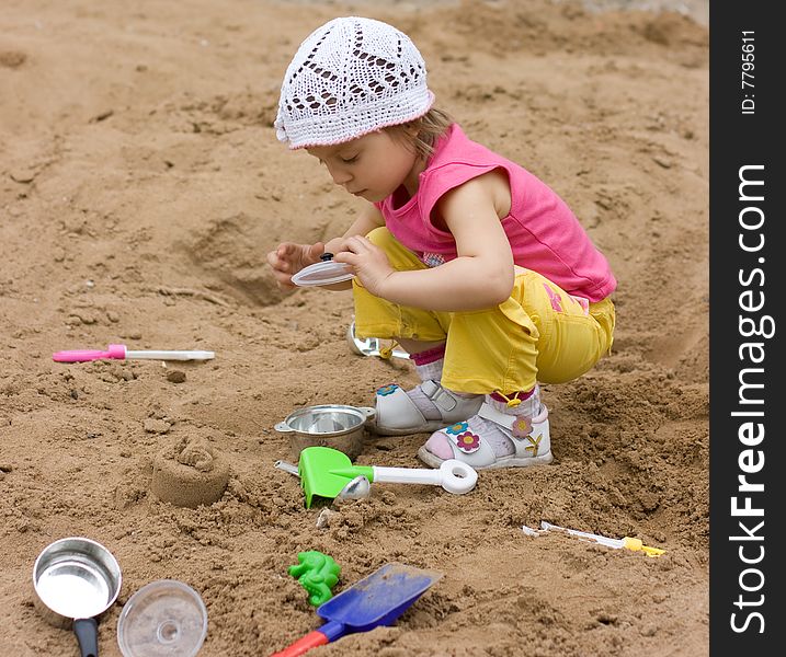 Little girl playing in sand