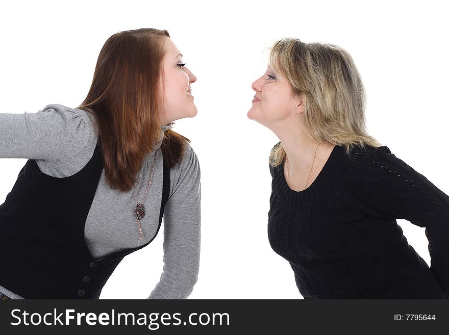 Two women look against each other and smile