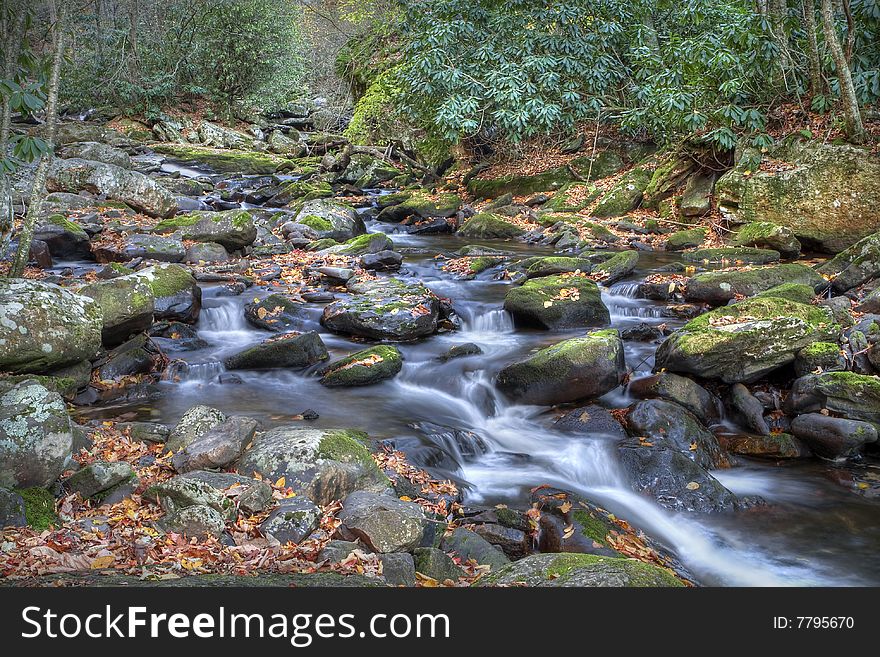 Beautiful mountain stream flowing through the mountain during fall.
