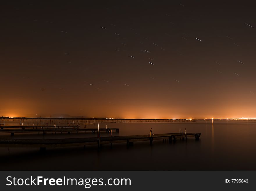 Long exposed stars over lake.