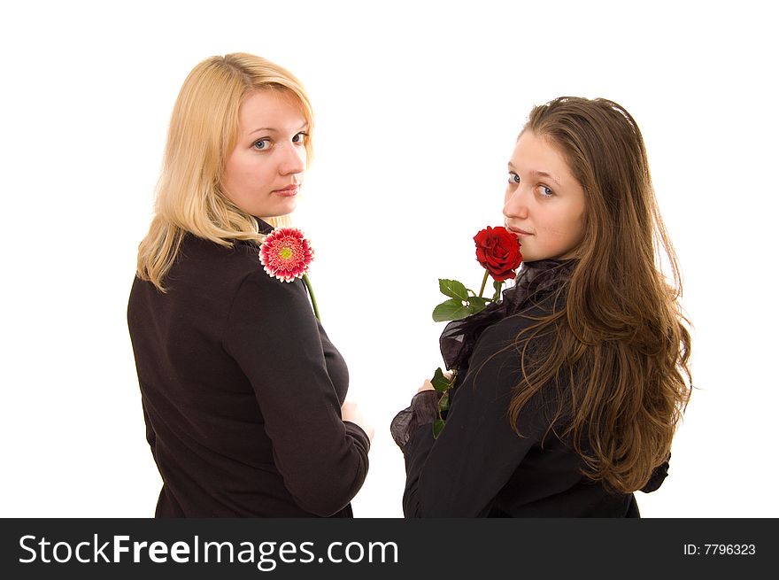 Portrait of two young women in black clothes with flowers on white. Portrait of two young women in black clothes with flowers on white