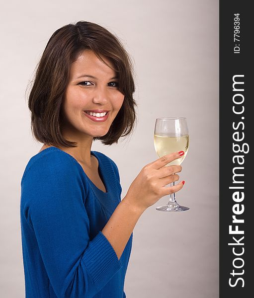 A beautiful young Asian-American girl drinking a glass of white wine