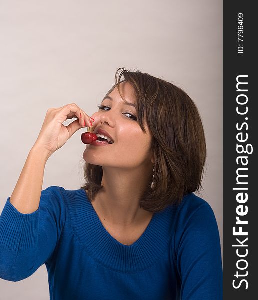 Girl eating red cherries