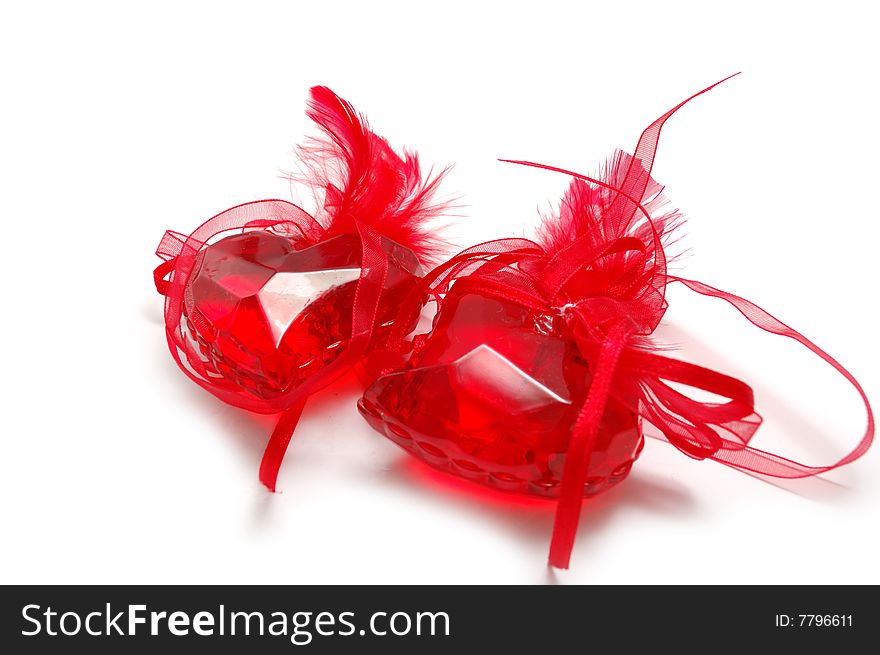 Two red glass hearts with plumage