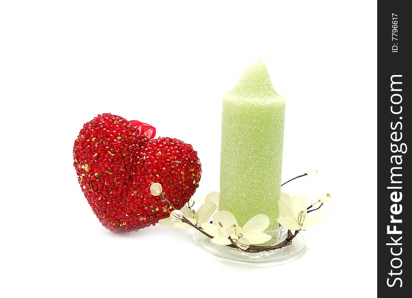 Red glass heart anf green candle. Red glass heart anf green candle