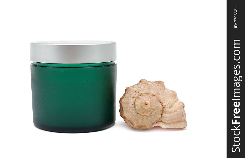 Spa concept - green bottle for cosmetics and seashell
