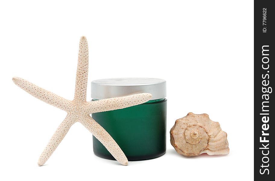 Spa concept - green bottle for cosmetics, seashell and seastar