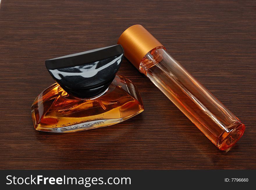 Bottle of perfume on a wooden background