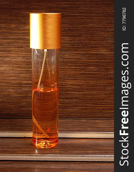 Bottle of perfume on a wooden background
