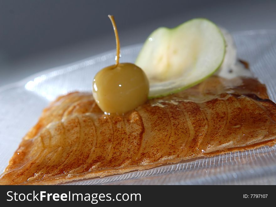 Apple pie with an apple on a plate