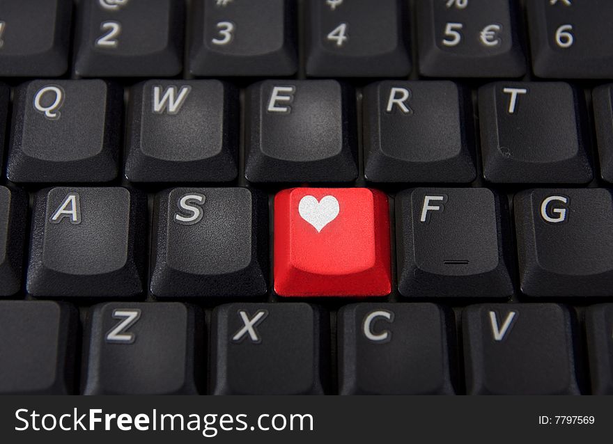 Keyboard with one red key with heart on it