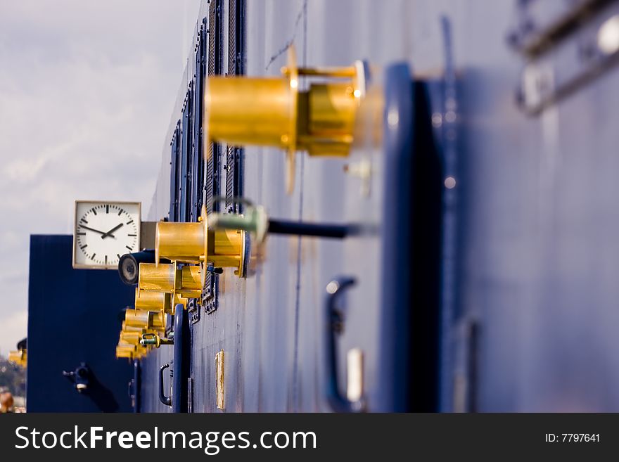 Gold Fixtures on the side of Blue Cruise Ship. Gold Fixtures on the side of Blue Cruise Ship