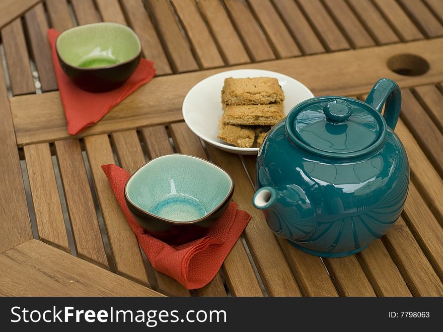 Teapot with cups & biscuits during lunch break in garden. Teapot with cups & biscuits during lunch break in garden