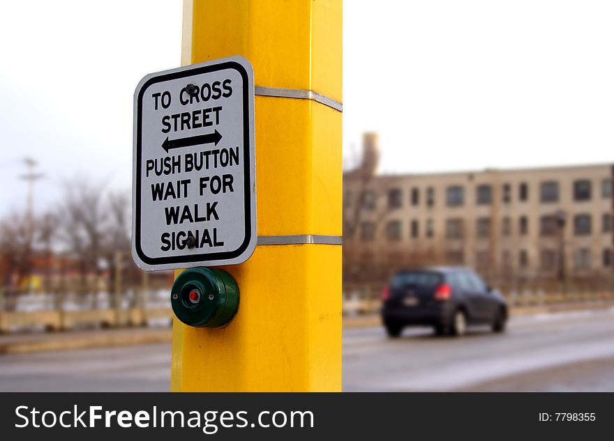 Button and sign at a traffic crosswalk. Button and sign at a traffic crosswalk.