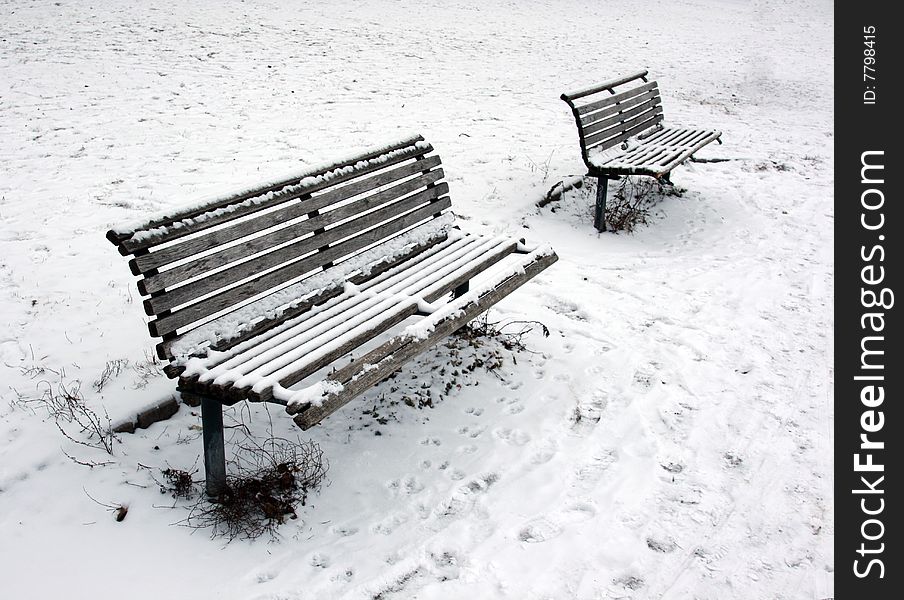 Snow covered benches at winter