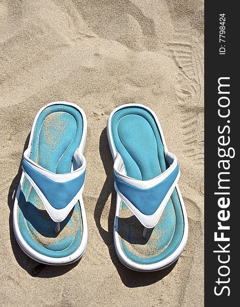 Blue sandals on the beach