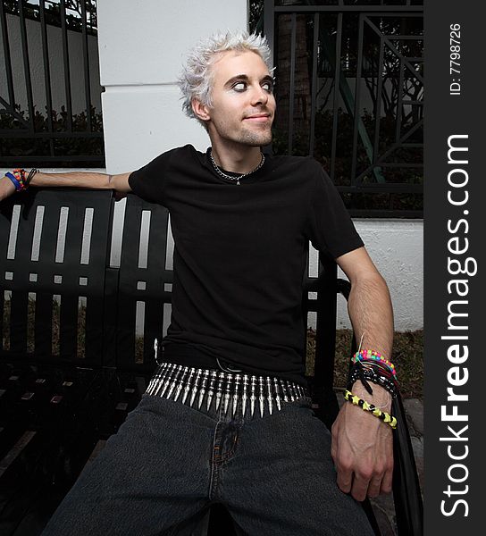 Young man sitting on a park bench. Young man sitting on a park bench