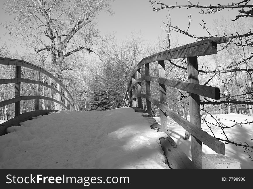 Monochrome wooden bridge covered with snow
