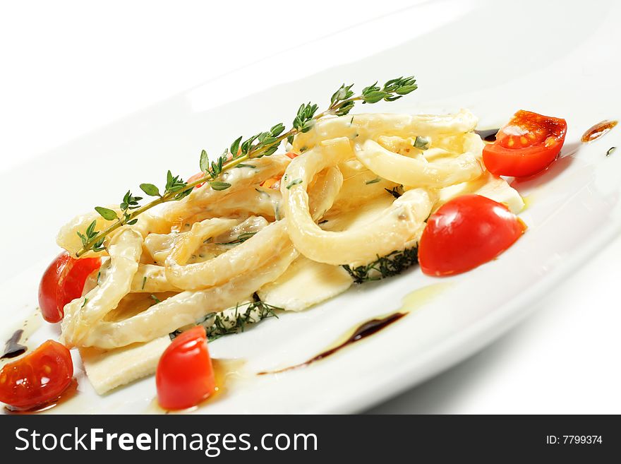 Salad with Calamari Rings, Sheep Cheese and Tomato. Isolated on White Background. Salad with Calamari Rings, Sheep Cheese and Tomato. Isolated on White Background