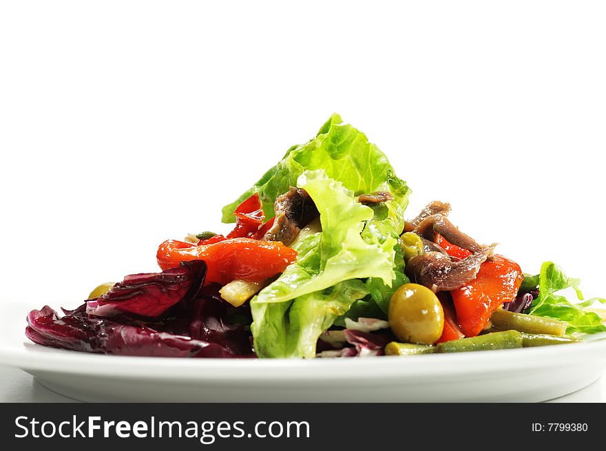 Salad with Anchovy, Olive and Vegetable Leaf. Isolated on White Background