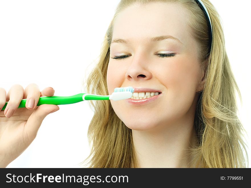 Attractive blond woman brushing her teeth
