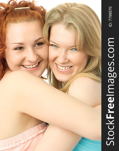 Portrait of two young happy embracing friends against white background. Portrait of two young happy embracing friends against white background