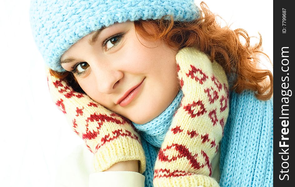 Beautiful ginger girl wearing a warm blue hat, scarf and mittens. Beautiful ginger girl wearing a warm blue hat, scarf and mittens