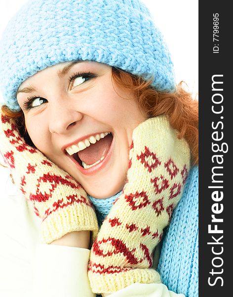 Happy excited ginger girl wearing a warm blue hat, mittens and scarf. Happy excited ginger girl wearing a warm blue hat, mittens and scarf