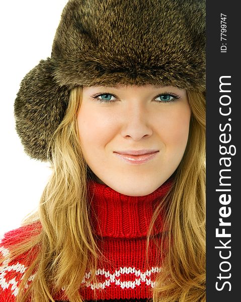 Portrait of a beautiful blond woman wearing a fur hat and warm red sweater. Portrait of a beautiful blond woman wearing a fur hat and warm red sweater