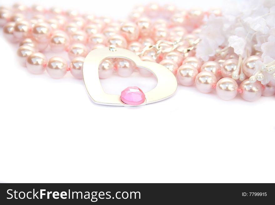 Necklace with heart and pink stone on it,pink pearls and white fabric flowers.