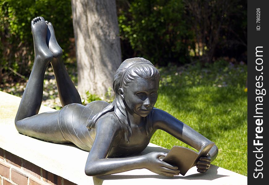 Statue of little girl reading book. Statue of little girl reading book