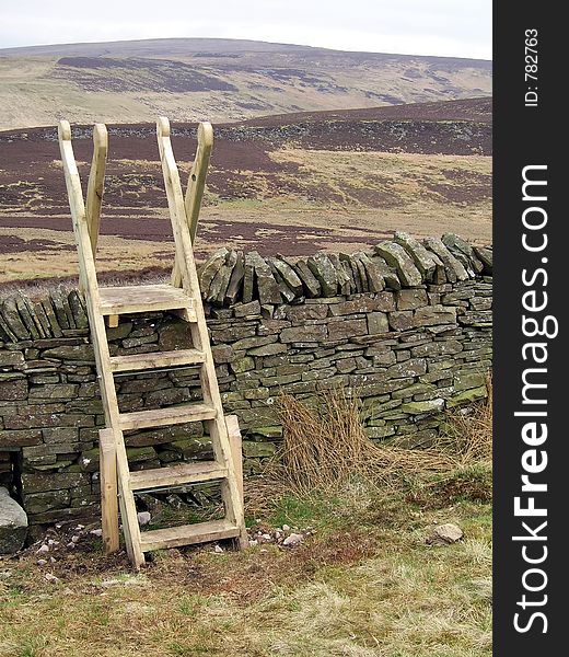 Ladders on a public right of way over a wall in the hills. Ladders on a public right of way over a wall in the hills